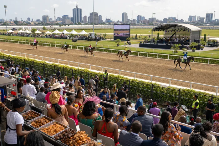 Horses racing at a Lagos stadium event with spectators, fashion displays and food vendors around the venue.